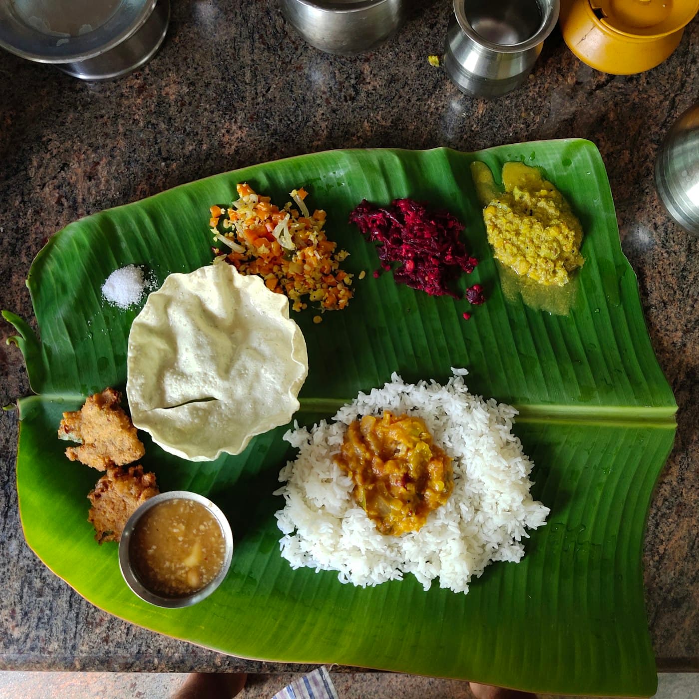 A South Indian meal of rice, sambar and vegetables served on a banana leaf