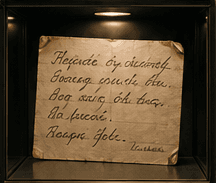 Handwritten recipe card for Barszcz czerwony, lit in a display case