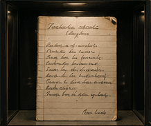 Handwritten recipe card for Pierogi ruskie, lit in a display case